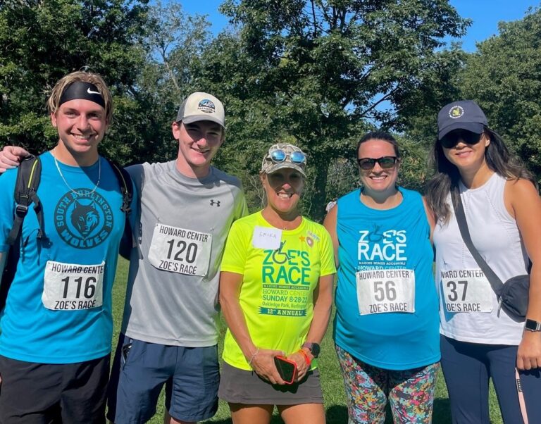 several people smiling at the camera after finishing a race