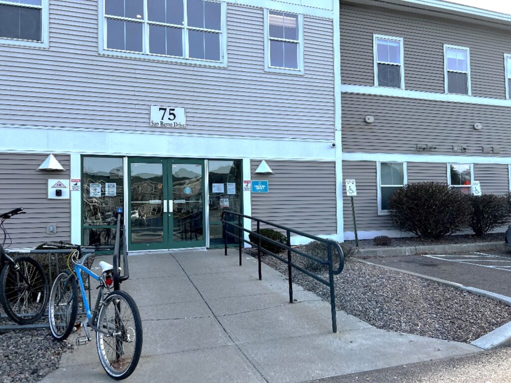 Photo of the main door at 75 San Remo Drive from the parking lot. Bike is locked to a post.